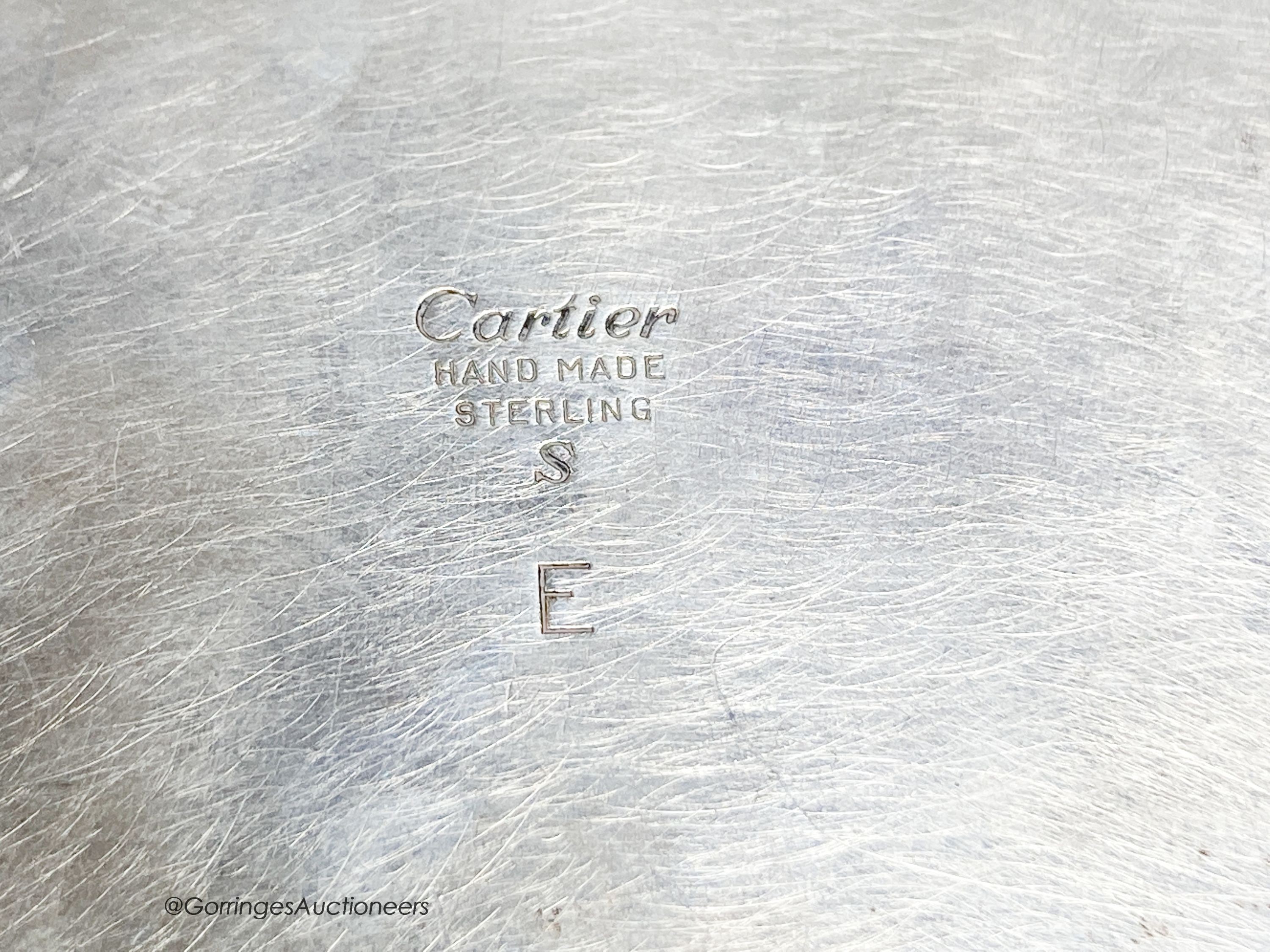 A 20th century Cartier sterling mounted rectangular cigarette box, on bun feet
